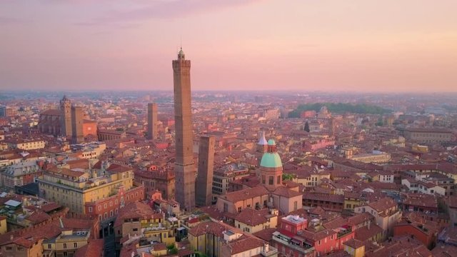 bologna city aerial view at sunrise flying backwards from two towers