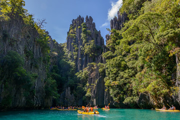 National Park and Reserve El Nido Palawan, Philippines. Tourists are kayaking in the small lagoon of Miniloc island