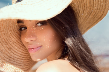 portrait of attractive girl posing in straw hat