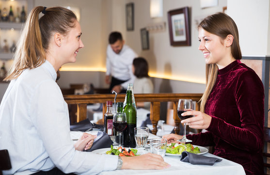 Two girls meeting in restaurant