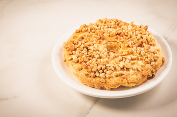 Baking with nuts on a white bowl and marble table/Baking with nuts on a white bowl and marble background, selective focus
