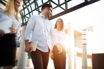 Picture of young attractive business partners standing