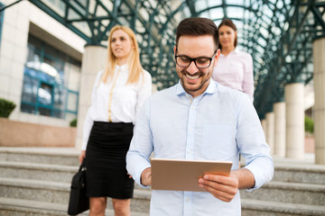 Businessman wearing glasses holding tablet