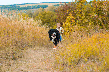 boy running around with big dog