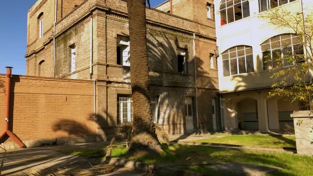 exterior structure and palms of the abandoned catholic convent Asylum of the Little Sisters of the Poor