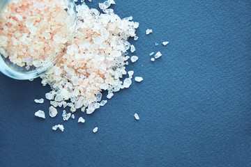 Himalayan pink salt in crystals above a gray stone