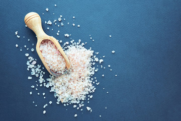 Himalayan pink salt in crystals above a gray stone