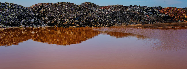 waste of mining industry rainwater colored with ferrous salts, pollution of the environment.