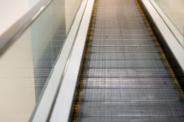 Escalator straight without steps. Moving Track at the supermarket or airport.