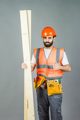 A construction man with boards or laminate in his hands. Repair and construction.