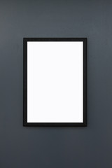 blank black frame on dark grey wall background and texture, white mock up for poster on grunge concrete panel.