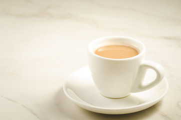white cup of tea with milk/white cup of tea with milk on a marble background, selective focus and copy space