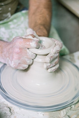 Ceramic dishes in working process. Creating ceramic pieces. Tradicional ceramic factory in spain. man working with traditional potter's wheel