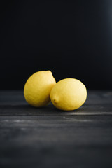 Fresh Lemon on vintage black wooden table