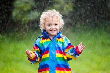 Little boy playing in the rain