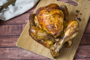 Heavily roasted grilled Chicken on wooden background