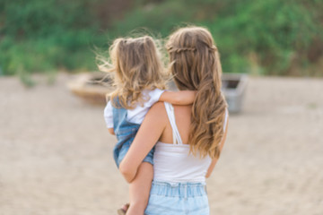 happy family at the beach. motherand child daughter hug