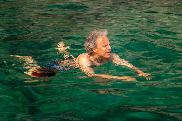 mature man having fun in the sea