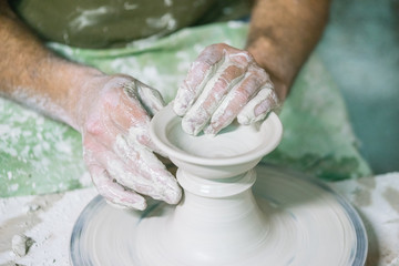 Ceramic dishes in working process. Creating ceramic pieces. Tradicional ceramic factory in spain. man working with traditional potter's wheel