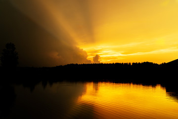 Yellow sunset with clouds and mirror