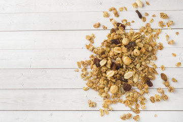 Dry Breakfast of oat flakes, granules and nuts. Muesli on a light table. Copy space