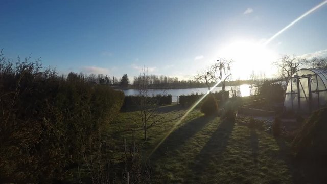 Timelapse of a sunrise over river and trees in the summer morning