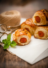 Small sausage rolls baked in pastry