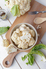 Organic cauliflower on wooden background