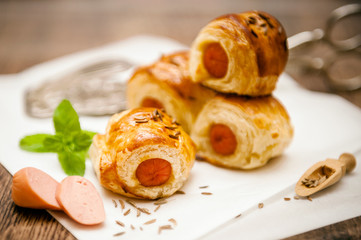 Small sausage rolls baked in pastry
