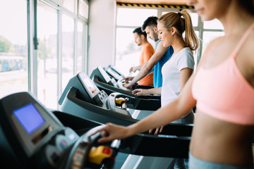 Fototapeta premium Happy people on treadmills in the gym