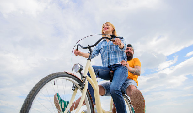Youth have fun riding bike sky background. Enjoy summer holidays vacation riding bike. Couple in love happy cheerful enjoy cycling together. Happy moments. Active leisure tips. Summer holidays ideas