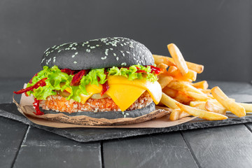 Hamburger with fries on a slate plate