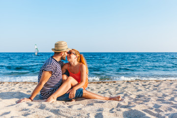 Young couple in love lying on the beach enjoying