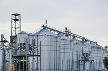 Complex of grain elevators for storing grain at dusk time.