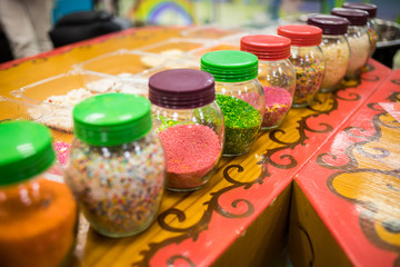 Colorful confectionery sprinkling in a glass jar, decoration for cake and bakery, a lot of sprinkles
