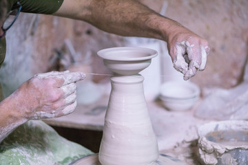 Ceramic dishes in working process. Creating ceramic pieces. Tradicional ceramic factory in spain. man working with traditional potter's wheel