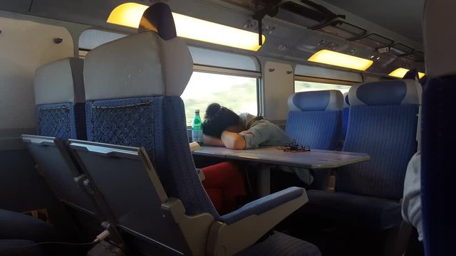 A woman sleeping in a TGV train