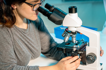 Female scientist researcher conducting an experiment in a laboratory