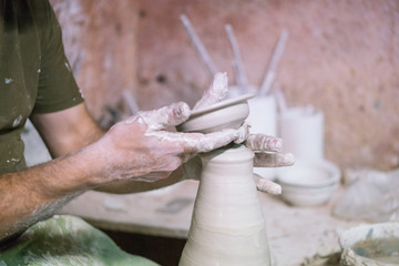 Ceramic dishes in working process. Creating ceramic pieces. Tradicional ceramic factory in spain. man working with traditional potter's wheel