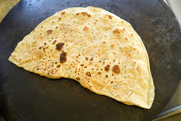 Turkish Gozleme.  Gozleme is a traditional Turkish dish featuring flat bread stuffed with a range of delicious fillings (cheese, patato, spinach, etc.) . Baked on sheet iron.
