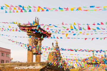 Prayer flags and decorations are held over Patan Durbar Square in Kathmandu, Nepal, during...