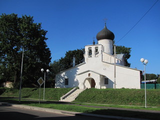 Landscape with a white Orthodox church, a sunny summer, Pskov