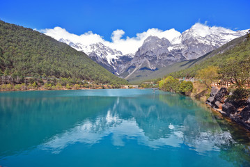 Fototapeta na wymiar Blue moon valley, beautiful blue lake with snow mountain reflection on water, attraction in Yulong or Jade Dragon snow mountain national park in Yunnan, Lijiang, China
