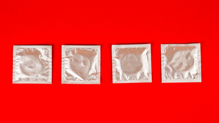 condom on red background. Safe sex concept