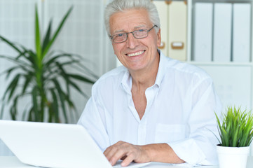  senior man using laptop