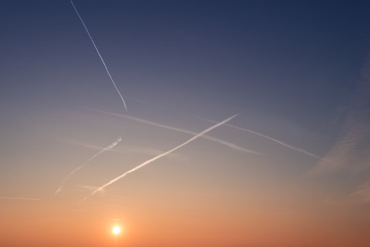 Awesome blue sunset sky with fiery sun.