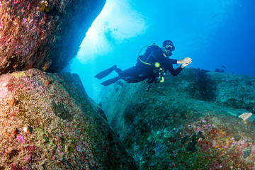 Fototapeta na wymiar SCUBA diver underwater on a tropical coral reef