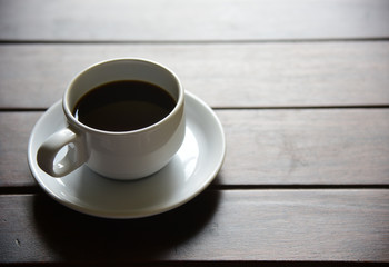 black coffee in cup on wooden table