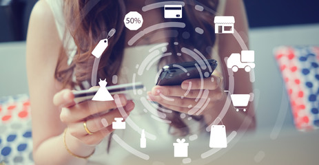 close up woman hand holding smartphone with virtual interface of shopping online circle technology concept