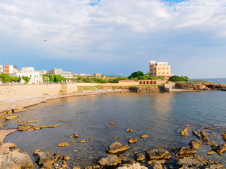 Fototapeta na wymiar View of the sea and a fragment of Alghero defensive walls. Sardinia, Italy.